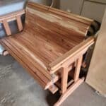 Handcrafted cedar porch swing for outdoor relaxation from Athens Woodcrafters.