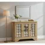 Elegant beige console table with glass-paneled doors and mirror in modern living room.