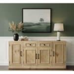 Natural wood sideboard with black handles in living room setting.