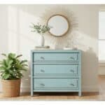 Beautiful robin's egg blue wooden console with gold knobs and a round sunburst mirror.