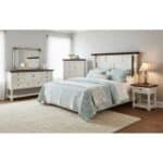 Elegant white bedroom furniture with blue bedding and wooden accents.