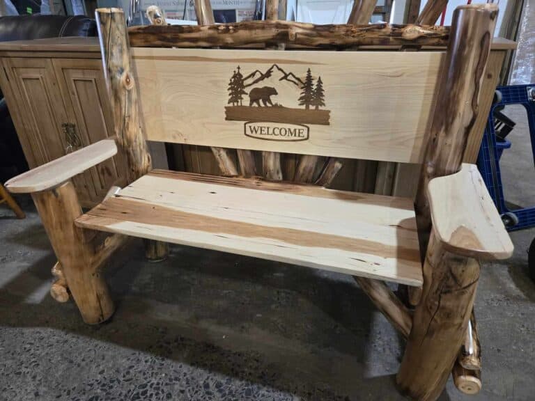 Rustic log bench with bear and nature scene, welcoming outdoor furniture piece.