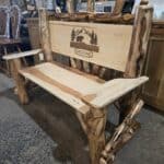 Rustic Amish log bench with engraved welcome sign for home decor.