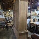 Large rustic wooden storage cabinet in furniture warehouse.
