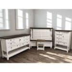Elegant white wood furniture with dark wood tops in a bright room.
