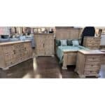 Wooden bedroom furniture set with bed, dressers, and nightstands in a showroom.