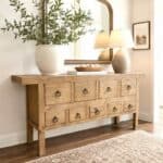 Rustic wooden buffet with drawers and decor in a cozy home setting.