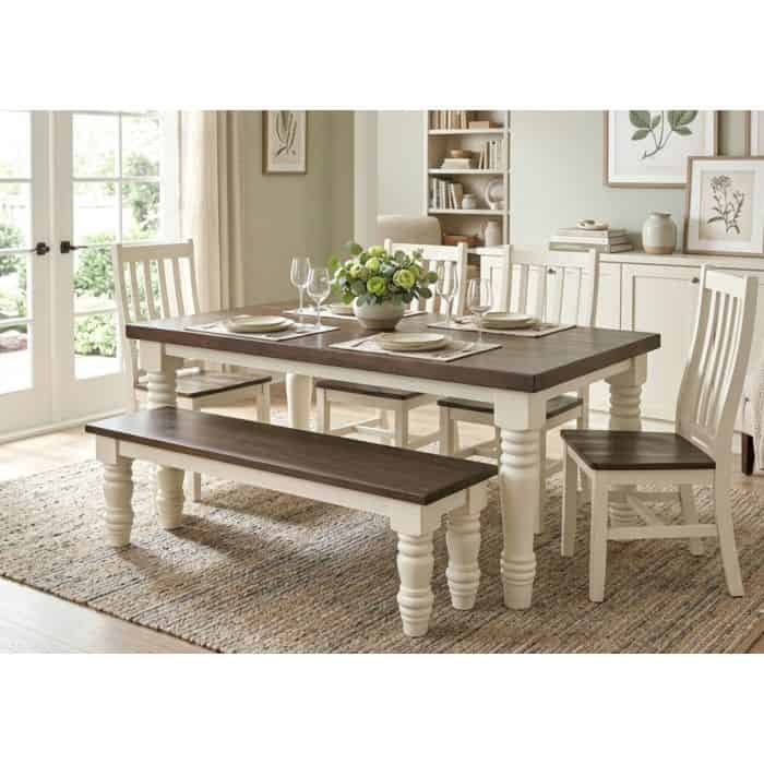 Farmhouse dining table with matching chairs and bench in a bright room.