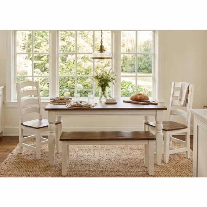 Elegant white and wood dining table with chairs in bright kitchen setting.
