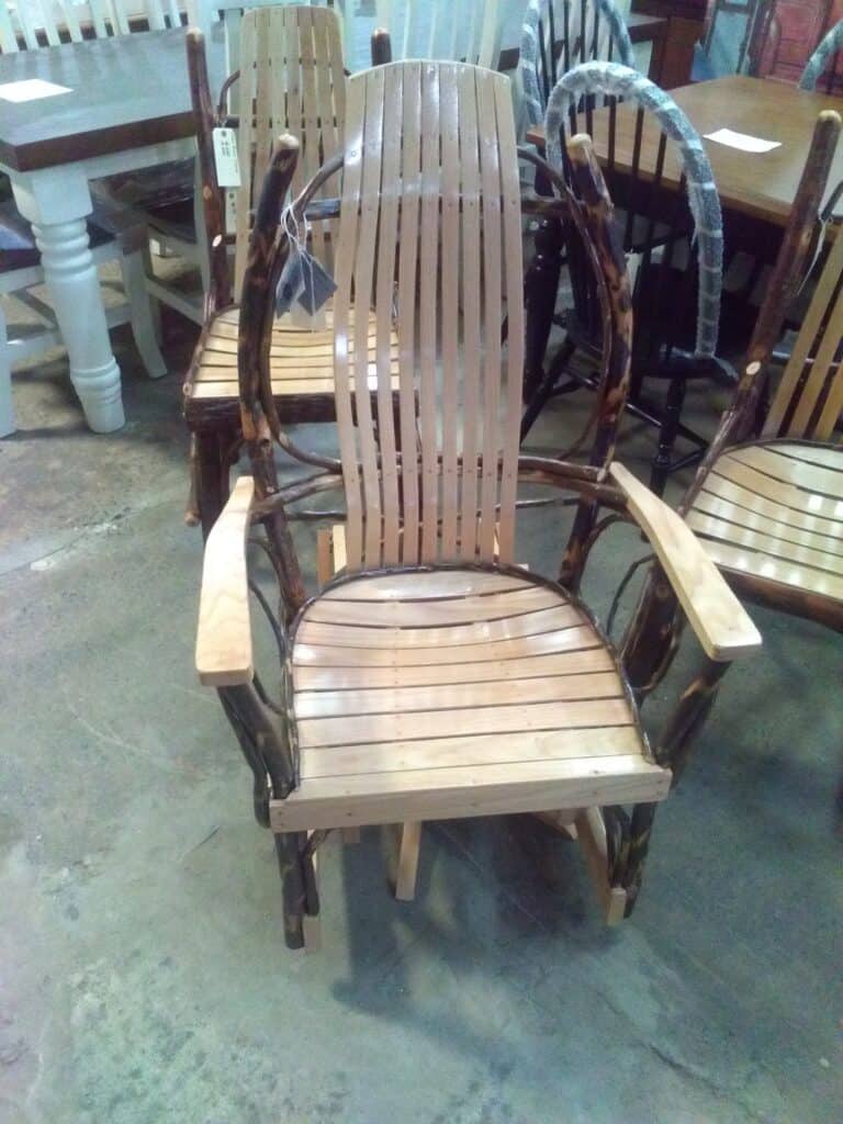 Handcrafted Amish gliding rocker with wooden slats and armrests.