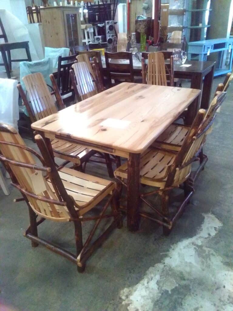 Amish dining table with matching chairs in a furniture showroom.