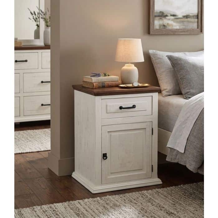 Frosted white nightstand with drawer and cabinet in bedroom setting.